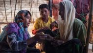 In a photo taken on November 30, 2017, a Rohingya woman is instructed on how to use a rape device issued by the Moonlight Development Society at a clinic in the Chakmarkul refugee camp in Cox's Bazar. AFP / Ed JONES 