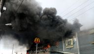 Smoke billows from a shopping mall on fire in Davao City, the Philippines, in this December 23, 2017 photo obtained from social media. Yas D. Ocampo/via REUTERS