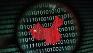 A map of China is seen through a magnifying glass on a computer screen showing binary digits in this photo illustration. REUTERS/Edgar Su 