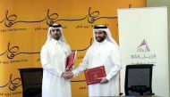 Qatar Post Chief Financial Officer Mohammed Jabr Al Naemi and Chief of Corporate Support, Khalifa Hassan Al Jehani, from Qatar Rail at the signing event.