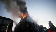 File photo of a burning building seen as smoke arises from it in Jecheon, South Korea, December 21, 2017. Yonhap via REUTERS