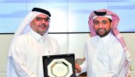 QU President Dr Hassan Al Derham (right) receiving a commemorative plaque from  Ashghal President Dr Eng Saad bin Ahmad Al Muhannadi.