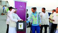 The students of Social Work course at Qatar University distributing winter-kits and other aid to workers under a Qatar Charity’s Local Winter Aids Programme. 

