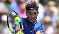 Rafael Nadal of Spain hits a backhand return against Richard Gasquet of France during the Kooyong Classic tennis tournament in Melbourne on January 9, 2018. AFP / WILLIAM WEST