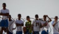 Inmates watching as injured prisoners are removed to receive medical care the day after a battle between gangs in the Alcacuz Penitentiary Center, where inmates remain armed and out of control, near Natal in Rio Grande do Norte, Brazil, January 20, 2017. 