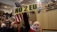A demonstrator holds a pro-Brexit sign and a US flag, as the speech by the Mayor of London, Sadiq Khan, is interrupted in central London, Britain January 13, 2018. REUTERS/Simon Dawson