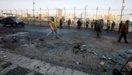 Iraqi security forces inspect the site of a bomb attack in Baghdad, Iraq January 15, 2018. REUTERS/Khalid al Mousily 
