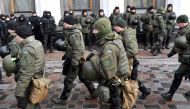 Police officer stand guard as activists call for the deputies to recognise Russia as an aggressor state during a rally in front of the Ukrainian parliament in Kiev, on January 16, 2018.  AFP / Sergei Supinsky