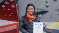 This photo taken on January 4, 2018, shows Nepali mountain guide Dawa Yangzum Sherpa posing with a mountaineering certificate in Kathmandu. AFP / Bikash Karki 