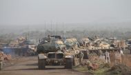Turkish soldiers are seen on the military vehicles as they move towards to Syrian border as part of the 