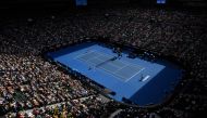 Spectators watch the men's singles match at the Australian Open tennis tournament in Melbourne. AFP / SAEED KHAN