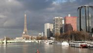 A picture taken on January 26, 2018, shows the flooded banks of the river Seine and the Beaugrenelle area and Eiffel Tower in the backround in Paris. AFP / Ludovic Marin 