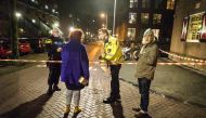 Policemen stand guard at a closed off lane following a shooting at the Grote Wittenburgstraat in Amsterdam on January 26, 2018.  AFP / ANP / Evert Elzinga