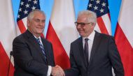 Secretary of State Rex Tillerson (L) and Polish Foreign Minister Jacek Czaputowicz shake hands during a joint press conference after their meeting in Warsaw on January 27, 2018. / AFP / Wojtek RADWANSKI