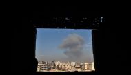 Smoke rises following a reported air strike in the rebel-held Syrian town of Mudayra, in the Eastern Ghouta region on the outskirts of Damascus, on January 28, 2018. / AFP / ABDULMONAM EASSA