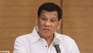 Philippine President Rodrigo Duterte gestures as he speaks during a press conference in Davao City, in the southern island of Mindanao on February 9, 2018. / AFP / -