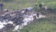 Israeli security forces walk next to the remains of an F-16 Israeli war plane near the Israeli village of Harduf, Israel February 10, 2018. REUTERS/Herzie Shapira ISRAEL OUT.