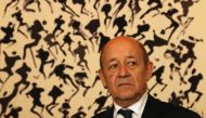 France's Foreign Minister Jean-Yves Le Drian stands in front of artwork by late Korean-born painter Lee Ungno as he attends a ceremony at the French embassy in Seoul on February 11, 2018 to launch the construction of a new embassy building. / AFP / Sebast