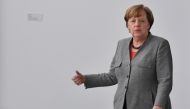 German Chancellor Angela Merkel walks out of her office to meet the President of the German Horticultural Association in the chancellery in Berlin, Germany, February 9, 2018. AFP / John MACDOUGALL