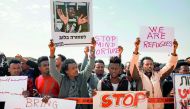 African migrants protest outside the Saharonim Prison, an Israeli detention facility for African asylum seekers near Holot, where at least nine others have been incarcerated as part of Israel's new policy of prison or deportation for migrants, in Israel's