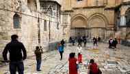 Worshippers and tourists visit the court near the closed doors of the Church of the Holy Sepulchre in Jerusalem's Old City February 26, 2018. Reuters/Ronen Zvulun
