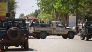 Burkinabe gendarme vehicles block a street in Ouagadougou on March 2, 2018, as the capital of Burkina Faso came under multiple attacks targeting the French embassy, the French cultural centre and the country's military headquarters.  / AFP / Ahmed OUOBA