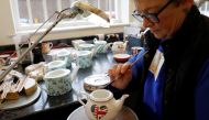 File photo of Sue Carter gilding a mug made to celebrate the Royal Wedding between Prince Harry and Meghan Markle at Halcyon Days' Caverswall factory in Stoke-on-Trent, Britain February 27, 2018. REUTERS/Darren Staples