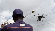 (FILES) In this file photo taken on July 10, 2017 an employee of the Ivorian Electricity company (CIE) pilots a drone that ensures the monitoring of the high voltage electric network at the Centre des Metiers de l'Electricite (Electricity Professional Cen