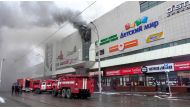 This handout picture released by The Russian Emergency Situations Ministry on March 25, 2018, shows emergency vehicles as they gather outside a burning shopping centre in Kemerovo. AFP PHOTO / RUSSIAN EMERGENCY SITUATIONS MINISTRY