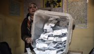 Electoral workers sort ballots to be counted at the end of the final day of the Egyptian presidential election in Cairo, Egypt, 28 March 2018.  AFP / Mohamed el-Shahed
