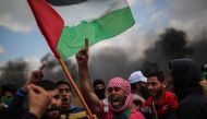 Demonstrators shout slogans and hold Palestinian flags during the demonstration under the name of the 