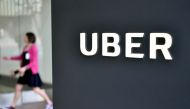 (FILES) In this file photo taken on February 5, 2018, a woman walks into the Uber Corporate Headquarters building in San Francisco, California. AFP / JOSH EDELSON