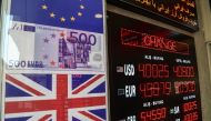 This picture is taken on April 10, 2018 in Istanbul shows a display of foreign exchange rates against Turkish liras at Istiklal avenue. / AFP / OZAN KOSE
