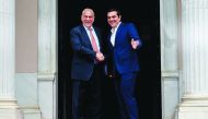 Greek Prime Minister Alexis Tsipras (R) welcomes Organization for Economic Co-operation and Development (OECD) Secretary General Angel Gurria (L) before their talks in Athens on April 30, 2018. AFP / Angelos Tzortzinis