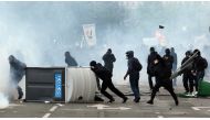 Masked protesters throw stones during clashes with French CRS riot forces at the May Day in Paris, France on May 01, 2018. ( Zakaria - Anadolu Agency )
