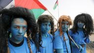 A group of Palestinian, dressed as Na'vi race in the movie Avatar, stage a demonstration to protest Israeli violations against Palestinians, within the 