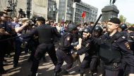 Russian police intervene to protestors as they gather during an opposition rally organized by the opposition leader Alexei Navalny, prior to the official inauguration of president Putin, in Moscow, Russia on May 05, 2018. Sefa Karacan - Anadolu 