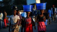 Women carry baskets with food items on their heads at a market in Blantyre, Malawi July 10, 2017. Picture taken July 10, 2017. Reuters/Siphiwe Sibeko