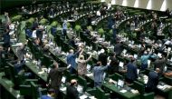 A handout picture provided by the Iranian Parliament on May 9, 2018 shows Iranian MPs chanting US slogans at the parliament in Tehran. AFP PHOTO / Islamic Consultative Assembly News Agency
 