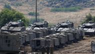 Israeli soldiers walk among armored vehicles in the Israeli-occupied Golan Heights, Israel May 10, 2018. REUTERS/Ronen Zvulun