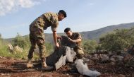 Lebanese soldiers inspect remains of a surface to air missile that landed in the southern Lebanese village of Hebarieh, early on May 10, 2018. AFP / Ali Dia