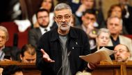 'Candidatura d'Unitat Popular' - CUP's (Popular Unity Candidacy) member of Catalan parliament Carles Riera gestures as he speaks at the session at the Catalan parliament in Barcelona on May 12, 2018. AFP / Pau Barrena
