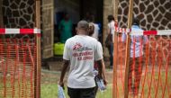 Doctors Without Borders (Medecins sans frontiere - MSF) team members walk through an Ebola security zone at the entrance of the Wangata Reference Hospital in Mbandaka, northwest of DR Congo on May 20, 2018. AFP / JUNIOR KANNAH