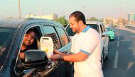A volunteer distributing Iftar boxes. 