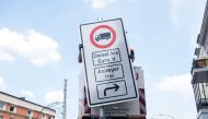 Picture taken on May 15, 2018 shows a worker fixing a driving ban sign for diesel trucks in Hamburg, northern Germany. From May 31, 2018, the city of Hamburg will ban some diesel vehicles from two major arteries to improve air quality, making the German p
