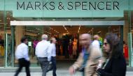 Pedestrians walk past a Marks and Spencer (M&S) shop in central London on May 23, 2018.  AFP / Daniel Leal-Olivas