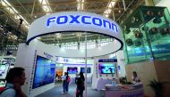 Visitors are seen at a Foxconn booth at the World Intelligence Congress in Tianjin, China May 19, 2018. Picture taken May 19, 2018. Reuters/Stringer