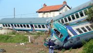 Italian police officers stand next to the twisted wreckage of a train that plowed into a truck last night in Caluso, near Turin, Italy, May 24, 2018. REUTERS/Massimo Pinca