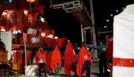 Migrants, part of a group intercepted aboard two dinghies off the coast in the Mediterranean Sea, enter a tent of the Spanish Red Cross after arriving on a rescue boat at the port of Malaga, Spain May 22, 2018. Picture taken May 22, 2018. REUTERS/Jon Nazc