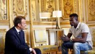 French President Emmanuel Macron (L) speaks with Mamoudou Gassama, 22, from Mali, at the presidential Elysee Palace in Paris, on May, 28, 2018. AFP / Pool / Thibault Camus